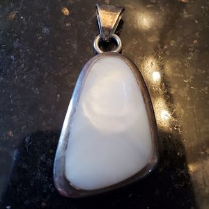 White stone and silver pendant.